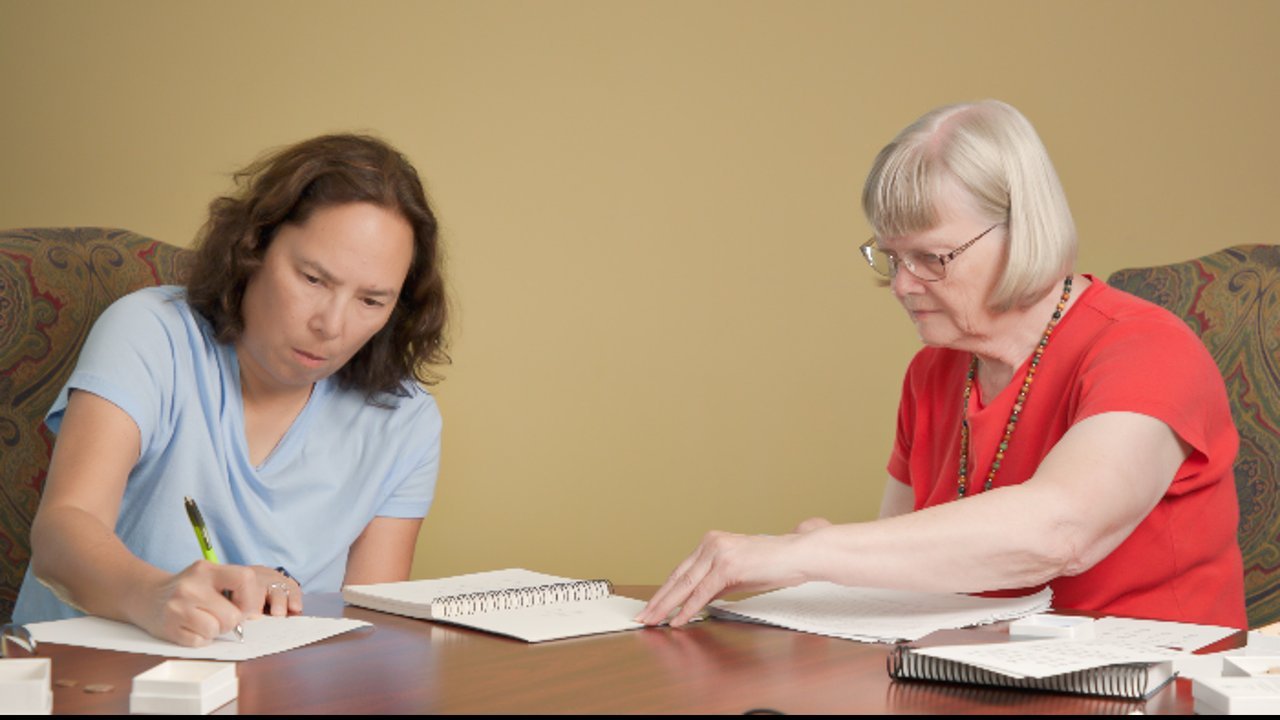 Dr. Ruth Geiman working through a General Processing Inventory with a learner at a table